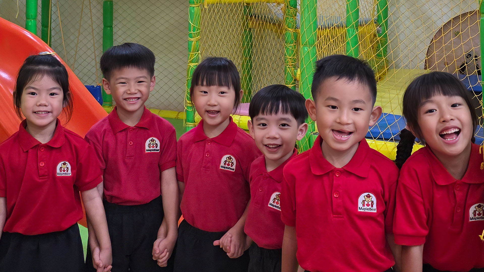 Happy children in MapleBear uniforms at our Jurong Gateway centre