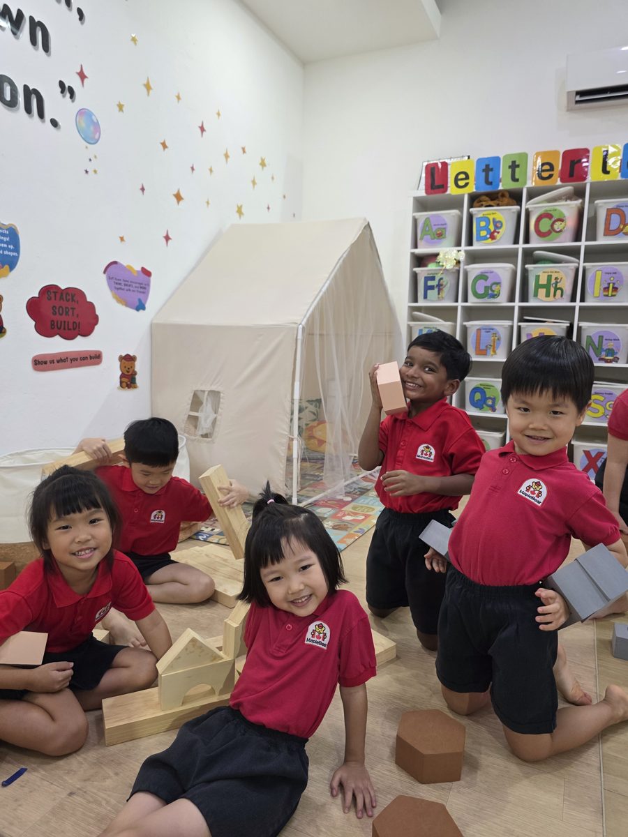 Children at MapleBear Jurong Gateway building with wooden blocks